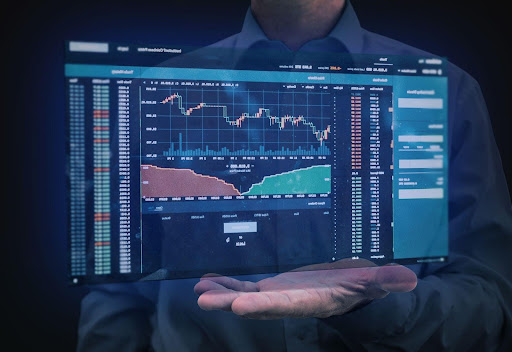 Digital stock trading dashboard hologram displayed above businessman�s hand showing market charts and data